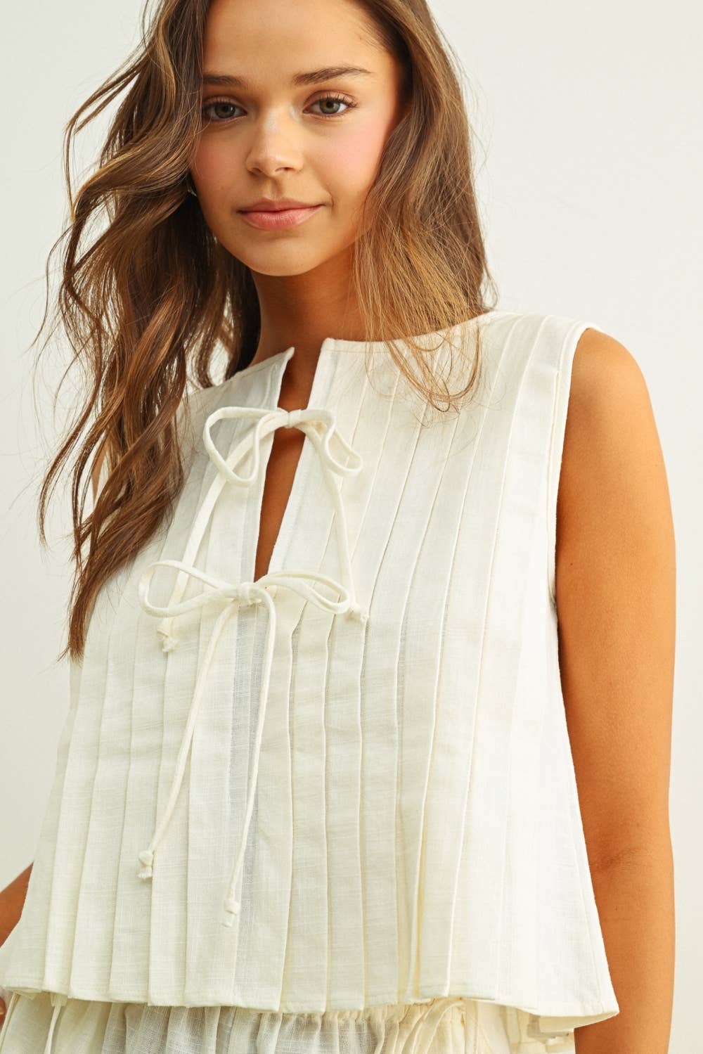 T6059ST   SLEEVELESS ALL PLEATED WITH TIE IN FRONT LINEN TOP